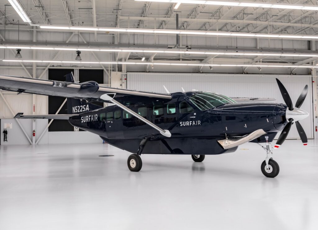 A Surf Air Cessna Grand Caravan side on in the hangar