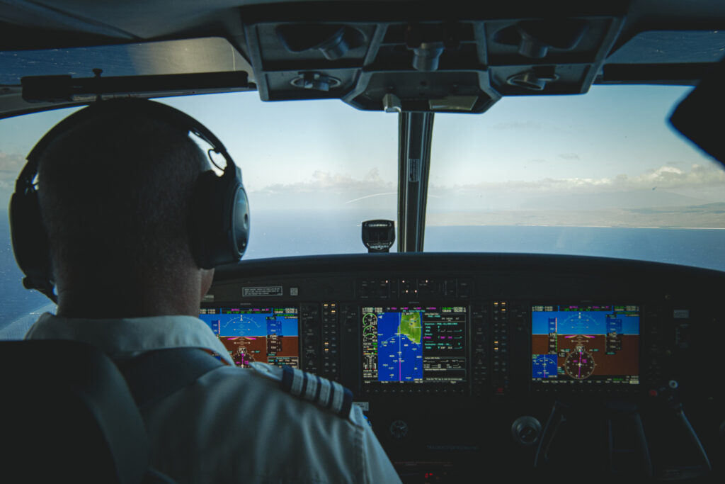 A pilot at the controls of a Cessna Grand Caravan